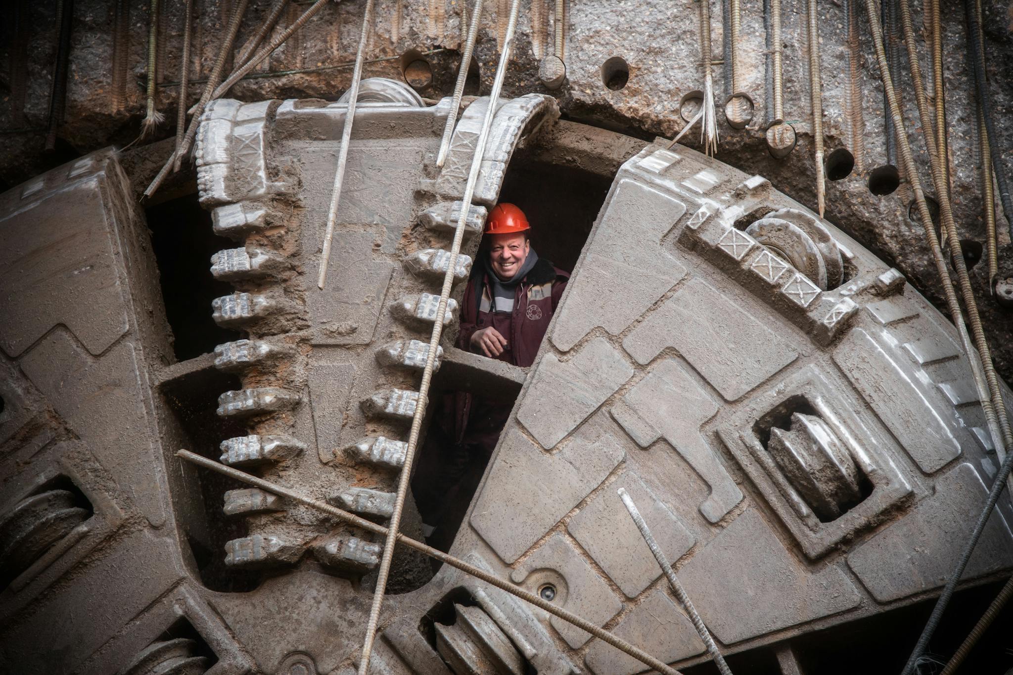 Construction worker stands inside massive tunneling machine in Moscow, Russia, showcasing industrial capability.